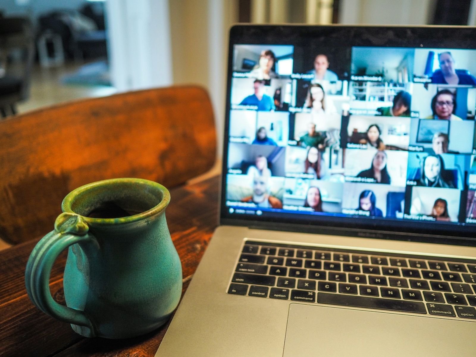 Laptop showing a video call with many participants